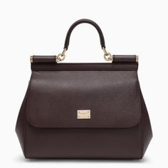 Medium grain leather handbag from Dolce & Gabbana featuring a front flap, a concealed press stud closure, a handle, an adjustable and removable shoulder strap, a logo plaque, an internal zip pocket with logo, a mobile phone pocket and metal feet.Width 26 cm x Height 21 cm x Depth 12 cm Adjustable shoulder strap length min 103 cm - max 120 cm Handle drop: 8 cm100% Calf leather Medium Handbags, Raffia Bag, Bottega Veneta Shoulder Bag, Logo A, Dolce E Gabbana, Louis Vuitton Shoulder Bag, Womens Crossbody Bag, Braided Leather, Dolce & Gabbana