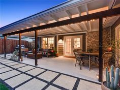 a covered patio with seating and lights on it