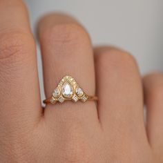 a woman's hand with a diamond ring on top of her finger and an engagement band