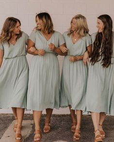 the bridesmaids are all wearing mint green dresses and tan sandals for their big day