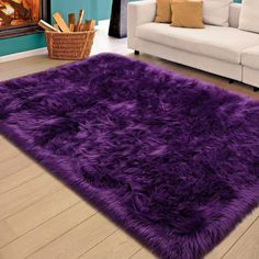 a living room with a white couch and purple rug