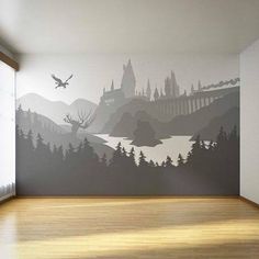 an empty room with a large mural on the wall and wood flooring in front of it