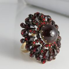 Estate 14k huge garnet cocktail ring size 7.5. 9.7 grams. 31mm face. great shape. could be a old conversion but not sure. maked 14k looks wonderful and supper unique. lite ware to center stone hard to see with eyes shows more in photo. Vintage Round Garnet Cluster Ring, Victorian Ruby Cluster Ring For Anniversary, Vintage Garnet Cluster Ring For Anniversary, Antique Cluster Ring Gift, Vintage Garnet Cluster Ring, Victorian Hallmarked Cluster Ring, Antique Round Cluster Ring Gift, Antique Style Cluster Ring As Gift, Antique Style Cluster Ring Gift