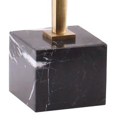 a black and white marble block with a gold top on it's end, in front of a white background