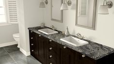 two sinks and mirrors in a bathroom with marble counter tops on both sides of them