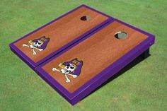 two purple and yellow cornhole game boards with a skull on the bottom one has an image of a football team