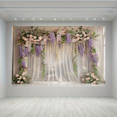 a white room with flowers on the wall and sheer curtains in front of it,