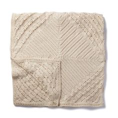 a crocheted blanket on a white background