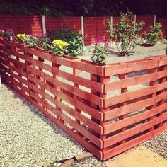 a wooden planter filled with lots of flowers