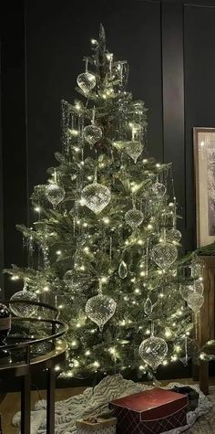 a white christmas tree with lights and ornaments