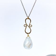 The Lunar Glow Necklace is a captivating piece that celebrates the ethereal beauty of moonlight. At its center, a large moonstone takes the spotlight, radiating its enchanting glow. Hanging from a delicate oxidized sterling silver chain is a hand-forged 14k gold filled swirling component, adding a touch of elegance and movement to the design. The intertwining swirls evoke a sense of cosmic energy and celestial allure. Embrace the mystical charm of our Lunar Glow Necklace, allowing it to become a