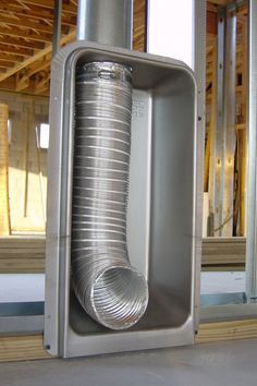 a large metal object sitting in the middle of a room with wooden framing around it