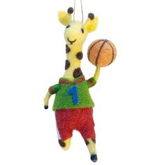 a stuffed giraffe is holding a basketball in its hand and wearing a green shirt