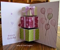 a birthday card with balloons and a gift box in the middle, on a table