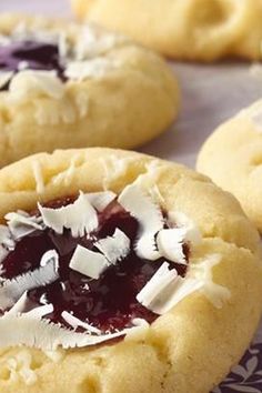 several cookies with jam and coconut on them