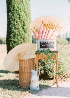 two parasols and an umbrella on display in the grass