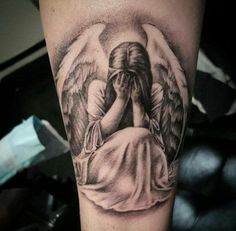 an angel with wings covering his face and hands is shown on the upper half of this arm