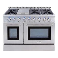 a silver stove with four burners and two oven doors on each side, in front of a white background