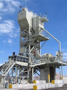 a large metal structure sitting on top of a road