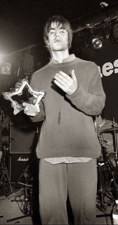 a man standing in front of a microphone holding something up to his face with both hands