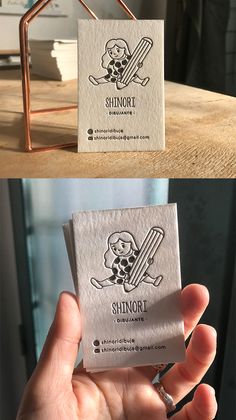 the business card is designed to look like a house with a skeleton holding a knife