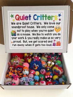 a box filled with lots of colorful little monster toys next to a sign that says quiet critters