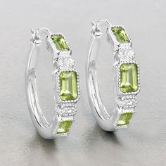 "Peridot Earrings, Genuine Peridot Earrings Sterling Silver, Peridot Earrings for Women, August Birthstone Hoop Earrings for Her Enjoy straight-up sparkle with these pretty stylish earrings. The oval peridot stones are beautifully set in .925 sterling silver with rhodium plating and have a total weight of 2.40 carats. These earrings boast an iridescent sparkle that you'll want to wear with everything. Make a big statement with these dazzling peridot earrings for women! Product Details:  .925 Ste Green Sterling Silver Hoop Earrings For May Birthstone, Green Gemstone Hoop Earrings For Anniversary, Green Hoop Earrings For Anniversary, Green Gemstone Hoop Earrings, Green Gemstone Hoop Earrings In Fine Jewelry Style, Green Hoop Earrings For Anniversary May Birthstone, Fine Jewelry Green Sterling Silver Hoop Earrings, Green Gemstone Accented Earrings For Anniversary, Peridot Earrings