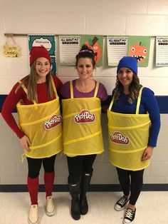 three girls in yellow aprons posing for the camera