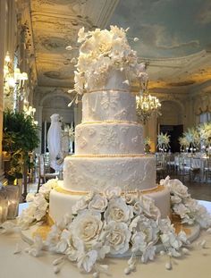 a large white wedding cake sitting on top of a table