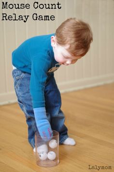 a little boy playing with some balls on the floor in front of his house count and relax game