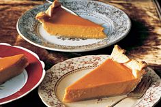 two plates with slices of pumpkin pie on them