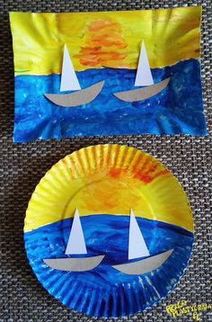 two paper plates with sailboats on them, one painted yellow and the other blue