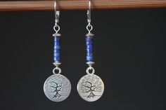 Inspired by nature, these blue dangle boho earrings are made with lapis lazuli stones, antique silver plated round charms featuring tree of life. They hang from sterling silver lever backs. These earrings are lightweight, comfortable and easy to wear everyday. They combine simplicity and charm to fit any casual or formal event. Color : Lapis Lazuli rondelle stones Finish : Sterling Silver lever back, Sterling Silver head pins, Antique Silver Round Tree Charms ( Lead and Nickel Free ). Length: 2- Bohemian Lapis Lazuli Teardrop Jewelry, Nature-inspired Blue Dangle Earrings, Blue Spiritual Dangle Earrings, Spiritual Blue Dangle Earrings, Blue Nature-inspired Drop Earrings, Handmade Lapis Lazuli Jewelry For Everyday, Bohemian Lapis Lazuli Earrings, Handmade Lapis Lazuli Bohemian Earrings, Blue Bohemian Sterling Silver Earrings