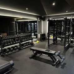 an empty gym with rows of exercise equipment