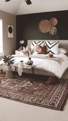 a bedroom with a bed, rugs and ceiling fan in it's center