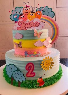 a multi layer cake decorated with butterflies and the number two on it's side