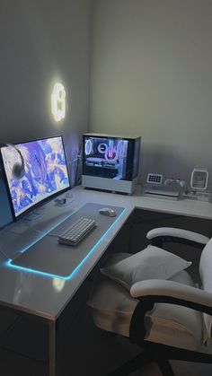 a computer desk with two monitors and a keyboard on it, in front of a white chair