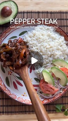 a plate with rice, meat and vegetables on it