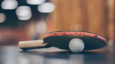 a ping pong paddle and ball on a table