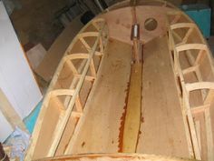 a wooden boat is being built in a workshop