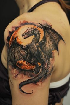 a woman with a dragon tattoo on her shoulder