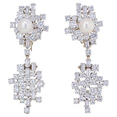 "You'll look stunning every time you don these dazzling earrings from our Estate collection. Each with a round pearl, measuring approximately 8mm attached to a baguette and round cut diamond top with dangling diamond bottom. Made in luxurious Platinum. Hanging length is 1 3/4". Clip-on. Bottom can be taken off and worn just as the top clip." Pearl Diamond Dangle Earrings, Dramatic Earrings, Diamond Top, Dazzling Earrings, Emerald Cut Diamond Ring, Diamond Dangle Earrings, Drop Dangle Earrings, Diamond Drops, Pearl Diamond