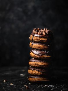 a stack of chocolate covered donuts sitting on top of each other