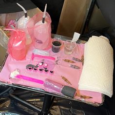 the table is covered with pink items and plastic bags