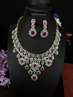 Ruby Pink Dubblet AD Stones/Necklace with Earrings/Premium Quality/ gold Finish/South Indian Jewelry/Asian Jewelry/Bridal Necklace Set. This item is perfect for parties and festivals! DETAILS: Includes One  Necklace and Two Earrings. Necklace: 3.10 inches. Adjustable length. Chain closure.  Weighs 2.35  oz ( 66g).  Earrings: 1.6 inch(es) long  Earring set weighs 0.35 oz ( 11g). Earring backs push on/off. Material: Imitation gold Finish Ruby Pink ,AD Stones. Finish: Premium Quality gold finish.  NOTE: I try my best to show you photos of my products as they appear in real life, but please note that variations in color occur due to differences in lighting and screen settings.  PRODUCT CARE: - Avoid contact with heat/fire, water, and chemicals such as perfumes or any sprays to prevent product Luxury Designer Necklaces For Diwali, Cheap Traditional Necklaces For Celebrations, Affordable Temple Jewelry Necklaces For Diwali, Luxury Temple Jewelry Danglers For Formal Occasions, Luxury Red Temple Necklace For Diwali, Luxury Ruby Chandbalis For Wedding, Luxury Festive Temple Necklace For Women, Luxury Heavy Temple Jewelry Danglers, Luxury Temple Necklace With Jewels For Celebrations