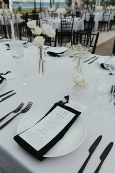 the table is set with black and white place settings