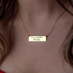 Introducing our exquisite gold bar necklace, a symbol of elegance and personalization. Crafted with meticulous attention to detail, this necklace combines timeless beauty with the allure of customization, creating a truly special piece of jewelry. Our personalized bar necklace features a sleek and slender gold bar, expertly engraved with the name, initials, or meaningful word of your choice. Each letter is carefully etched onto the surface, creating a stunning and unique design that holds deep significance. Choose between a vertical or horizontal orientation, allowing you to express your individual style. The minimalist design of the gold bar necklace exudes understated sophistication, making it a versatile accessory that effortlessly complements any outfit, from casual to formal. The dain Engraved Rectangular Necklace For Mom, Engraved Rectangular Jewelry For Mom, Engraved Rectangular Jewelry Gift For Mom, Rectangular Gold Jewelry Gift For Mom, Rectangular Gold Jewelry As Gift For Mom, Gold Rectangular Necklace As Gift For Mom, Rectangular Gold Necklace As Gift For Mom, Gold Rectangular Pendant Jewelry Gift For Mom, Gold Rectangular Pendant Jewelry As Gift For Mom