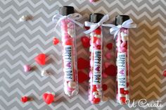 two valentine's day candy tubes with hearts on them