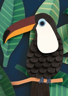 a paper cut out of a toucan sitting on a branch