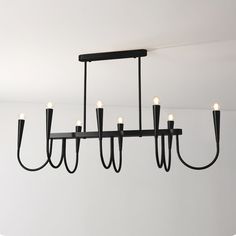 a black chandelier with five lights hanging from it's center and four arms